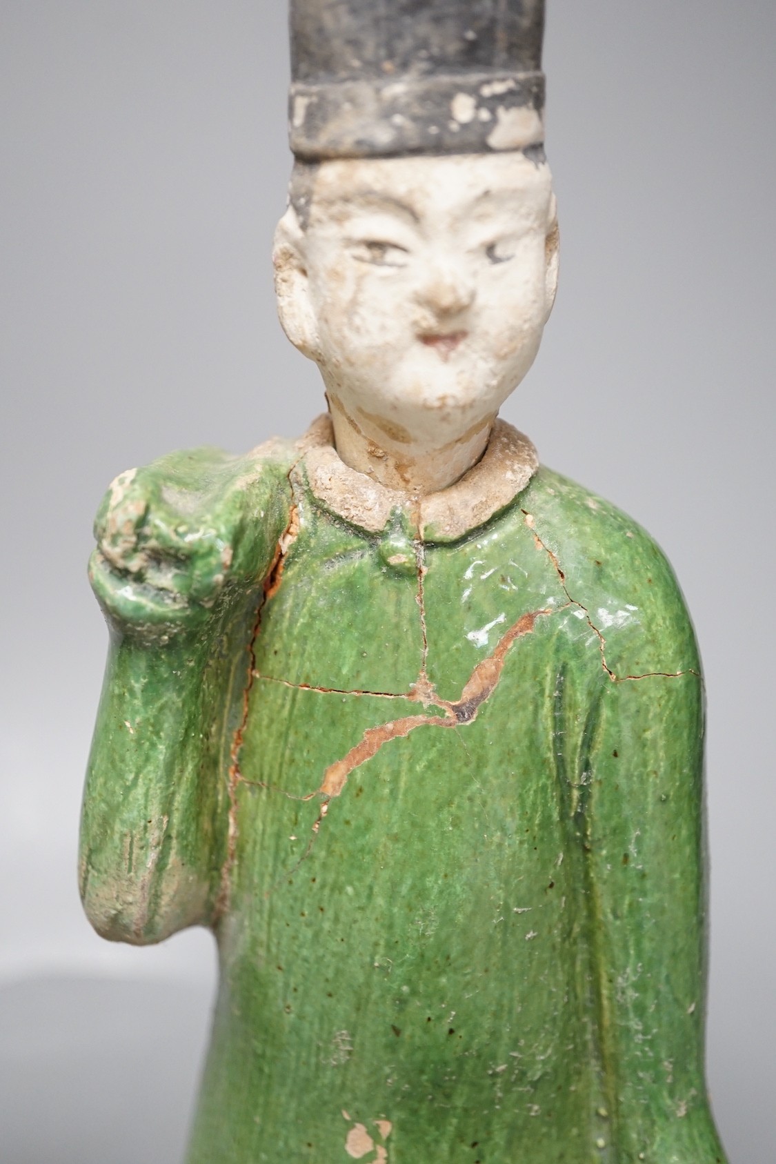 Three Chinese Ming pottery figures of attendants, 28cm tall
